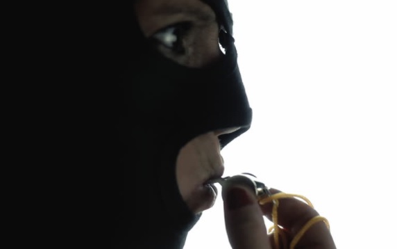 masked man blowing whistle
